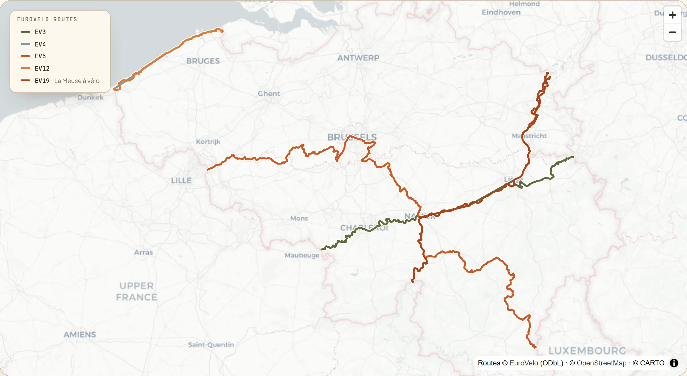 Map of Belgium with five signed EuroVelo routes — EV3 the Pilgrims Route across Wallonia from the German border to Maubeuge, EV4 and EV12 sharing the North Sea coast from De Panne to Knokke-Heist, EV5 the Via Romea diagonal through Brussels, and EV19 La Meuse à vélo up the Meuse from Dinant to Visé.