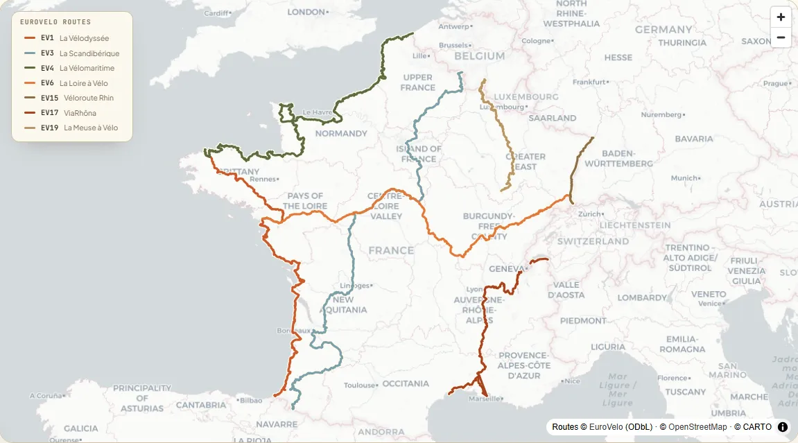 Map of France with the seven signed EuroVelo routes each drawn in its own colour — the Atlantic and Channel coasts, the Loire, the Rhine, the Rhône and the Meuse.